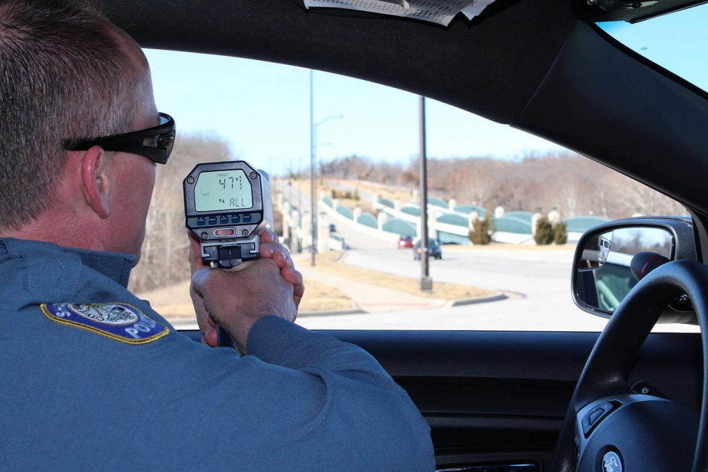 Police officer using speedometer